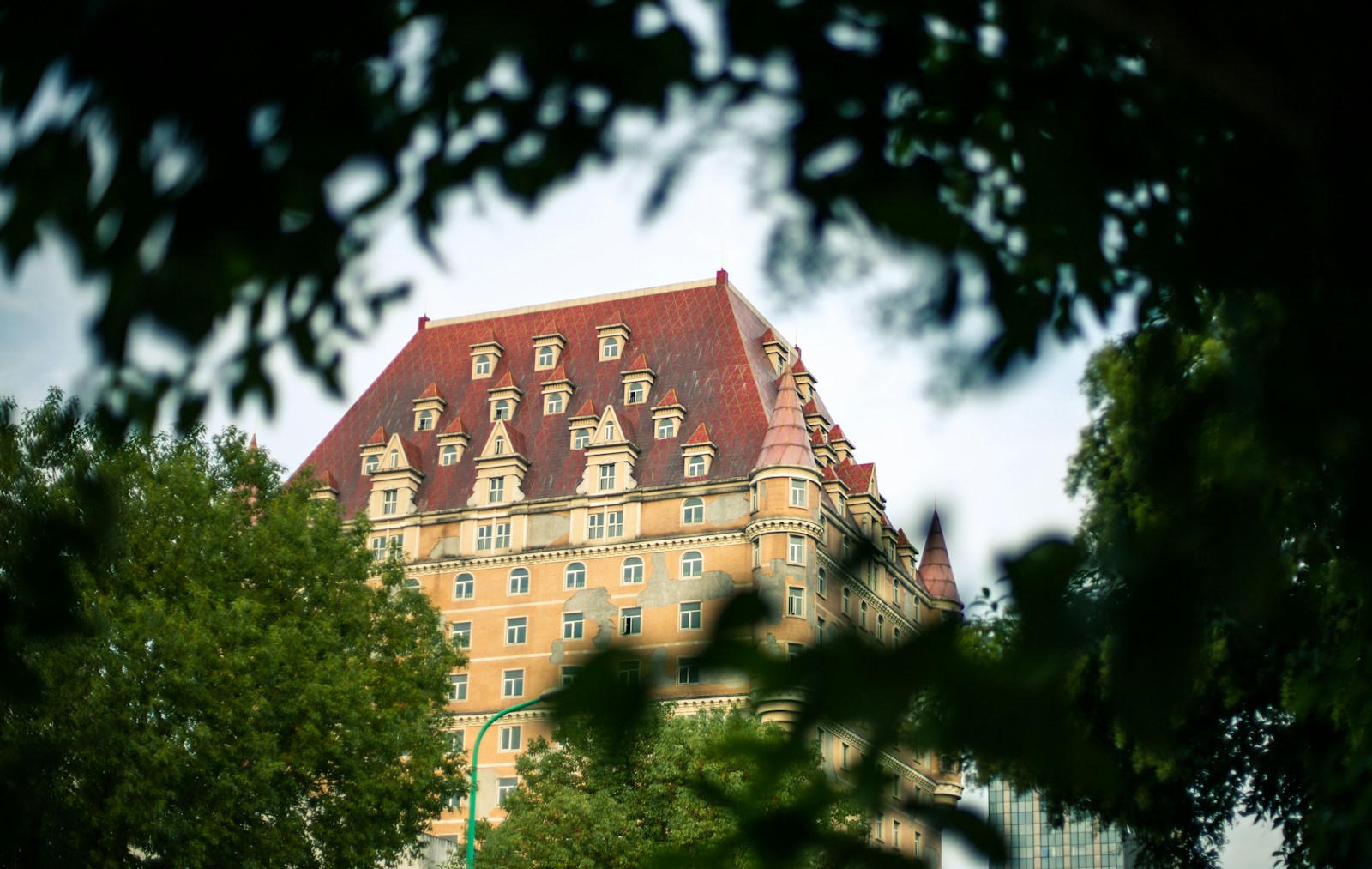 a large building with a red roof surrounded by trees